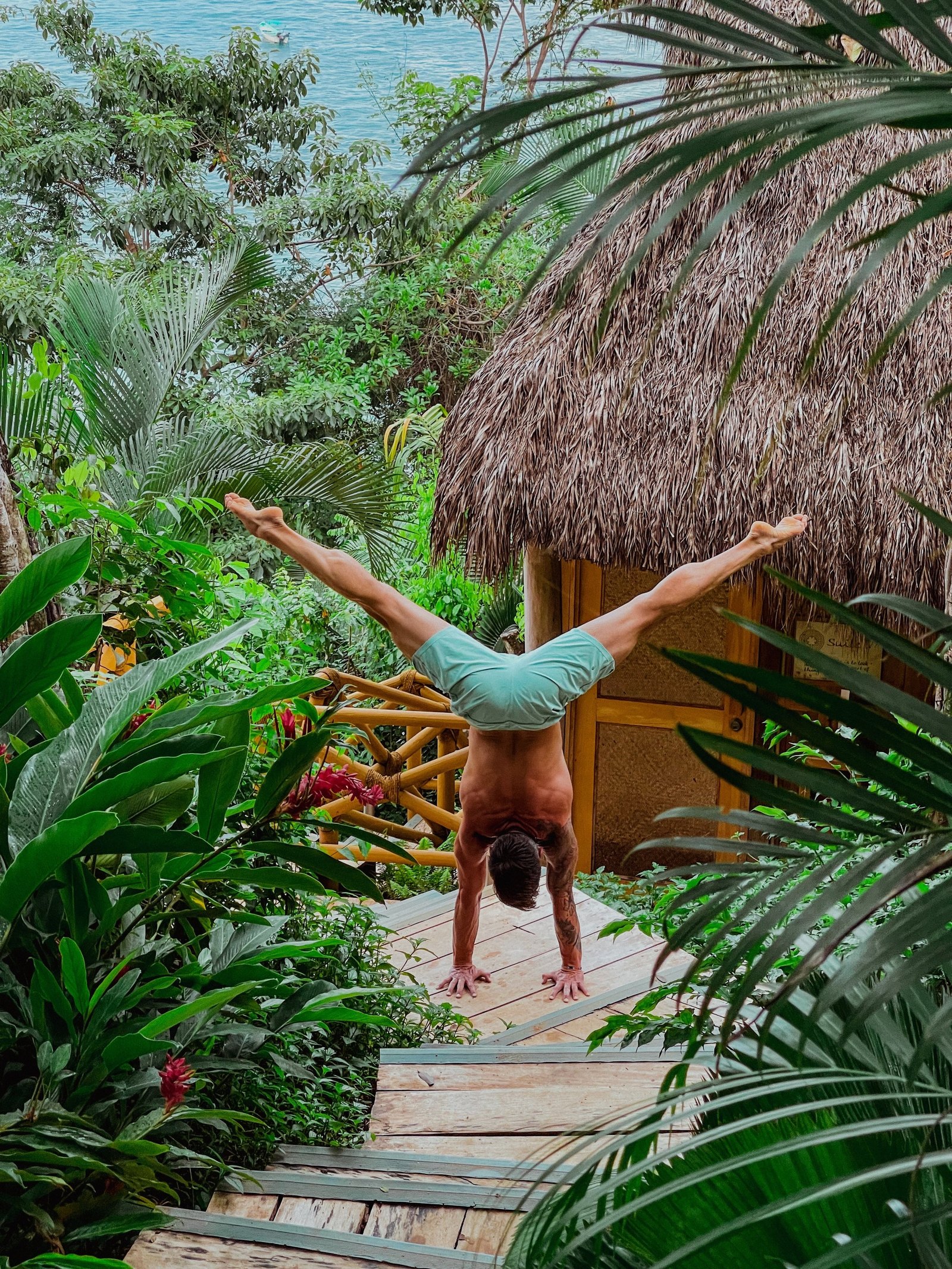 A handstand held on a jungle pathway