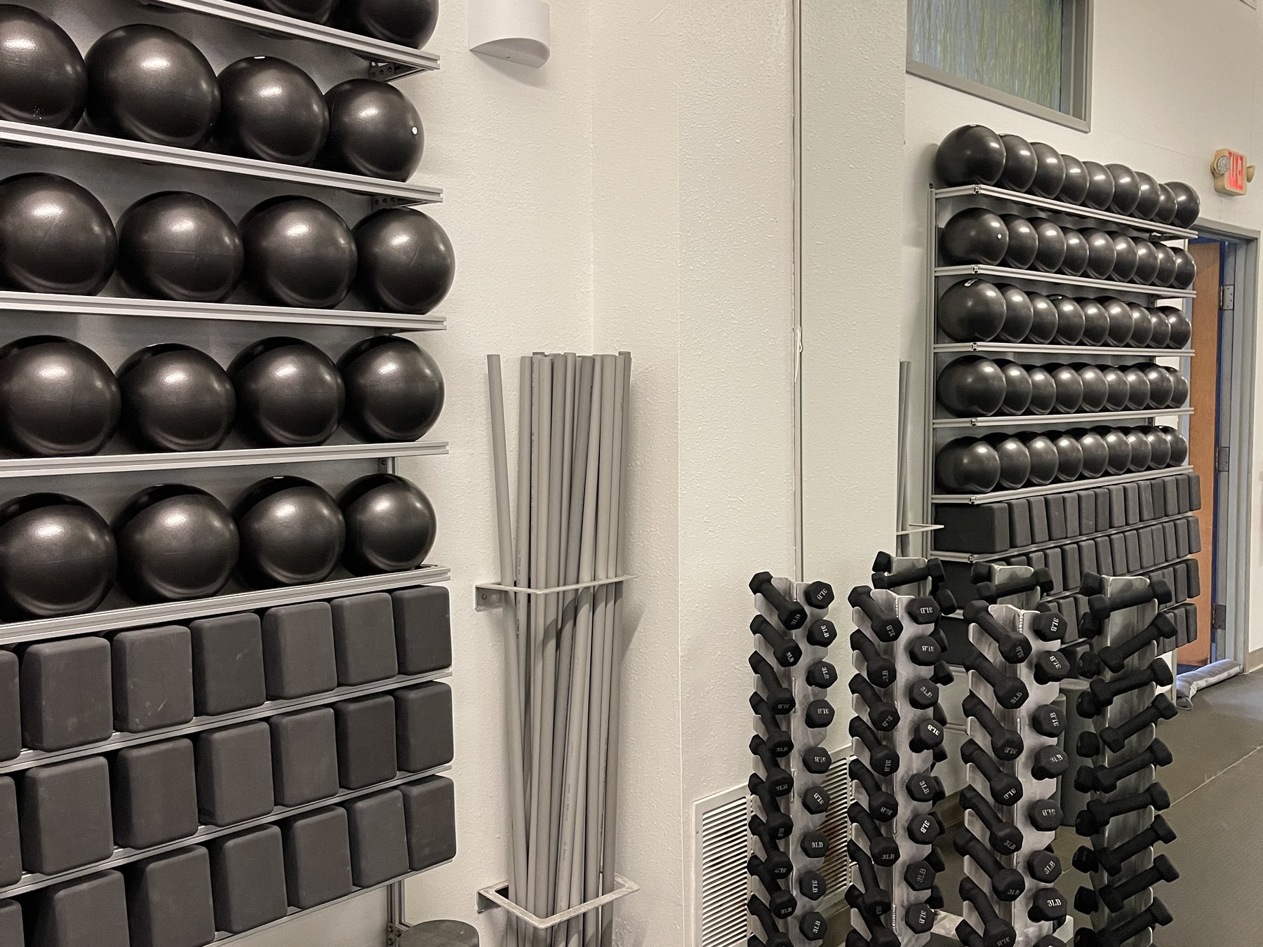 The prop wall at SWEAT, stability balls, blocks and foam rollers racked and ready